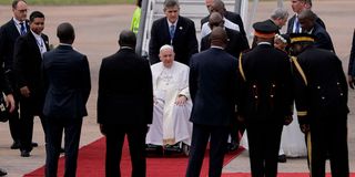 Pope Francis alights from his plane at the N'djili International Airport