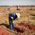 An Avalon Cemetery worker digs a grave in the graveyard section at the Avalon Cemetery in Soweto