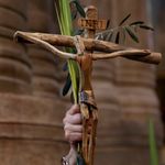 A Catholic pilgrim holds up a crucifix and a palm branch during the Palm Sunday procession in Jerusalem.