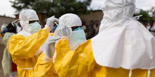 Health workers wearing protective gear at an Ebola treatment centre.